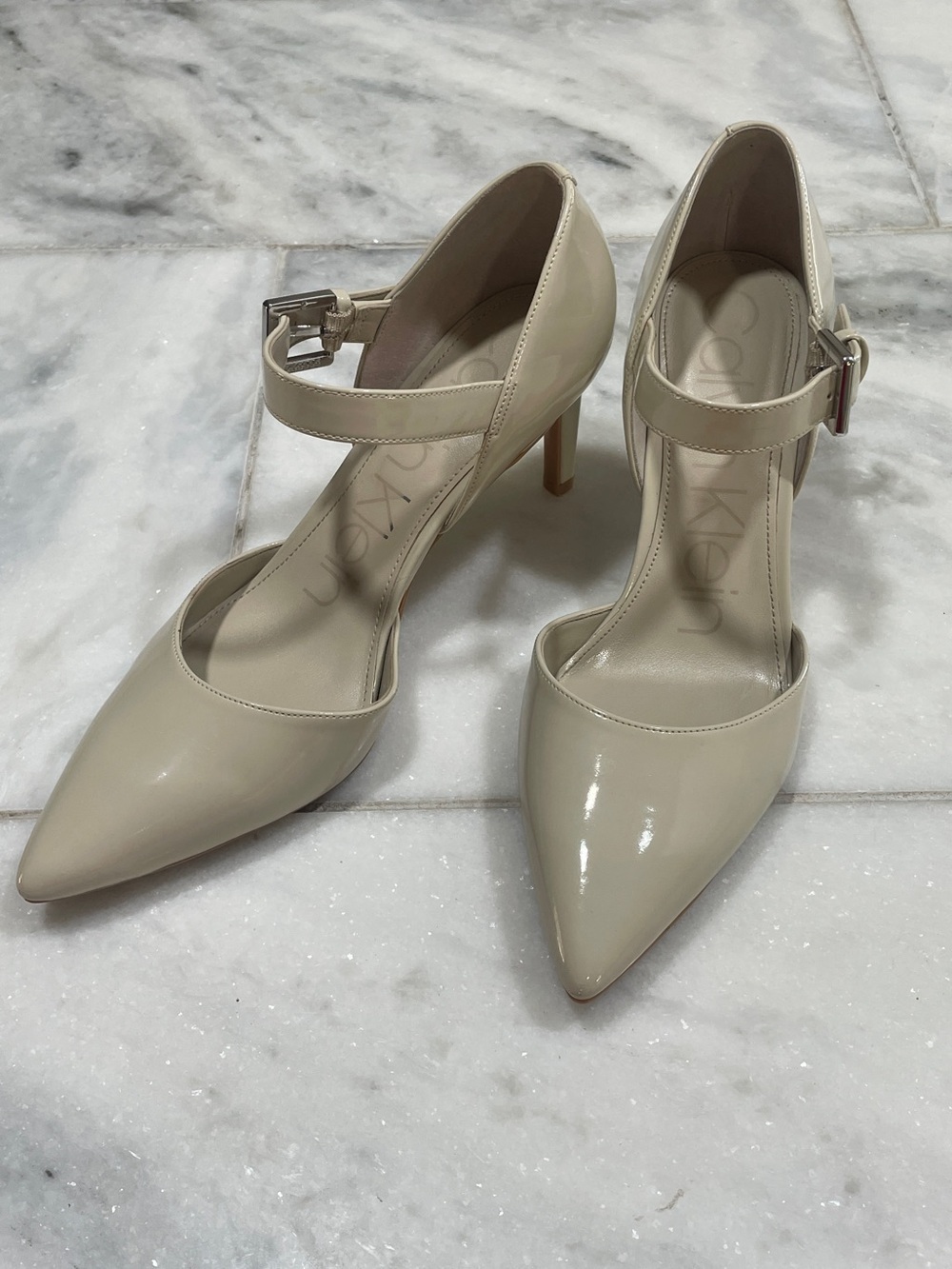 Calvin Klein Nude/Cream Patent Pointed Toe Heels 7.5M 3” Heel Silver Logo Buckle